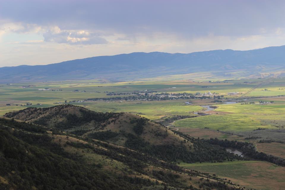 Green fields and mountain ranges surrounding Grace, Idaho